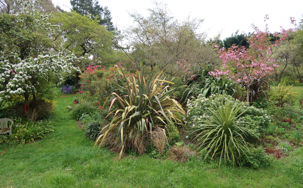  With flowering shrubs and trees. 