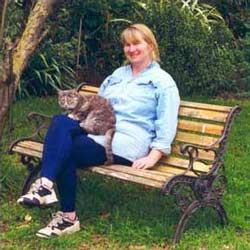  A gardener and a cat relaxing. 
